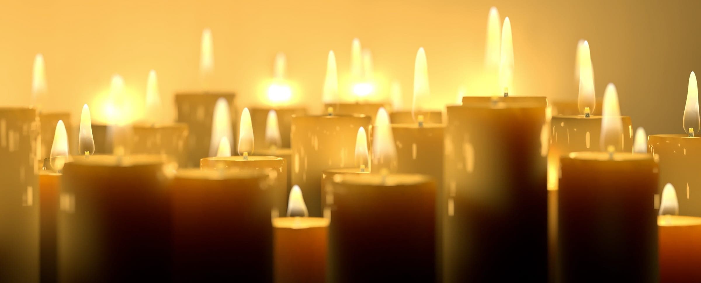 Lit candles on display inside The Clinton Candle Co.